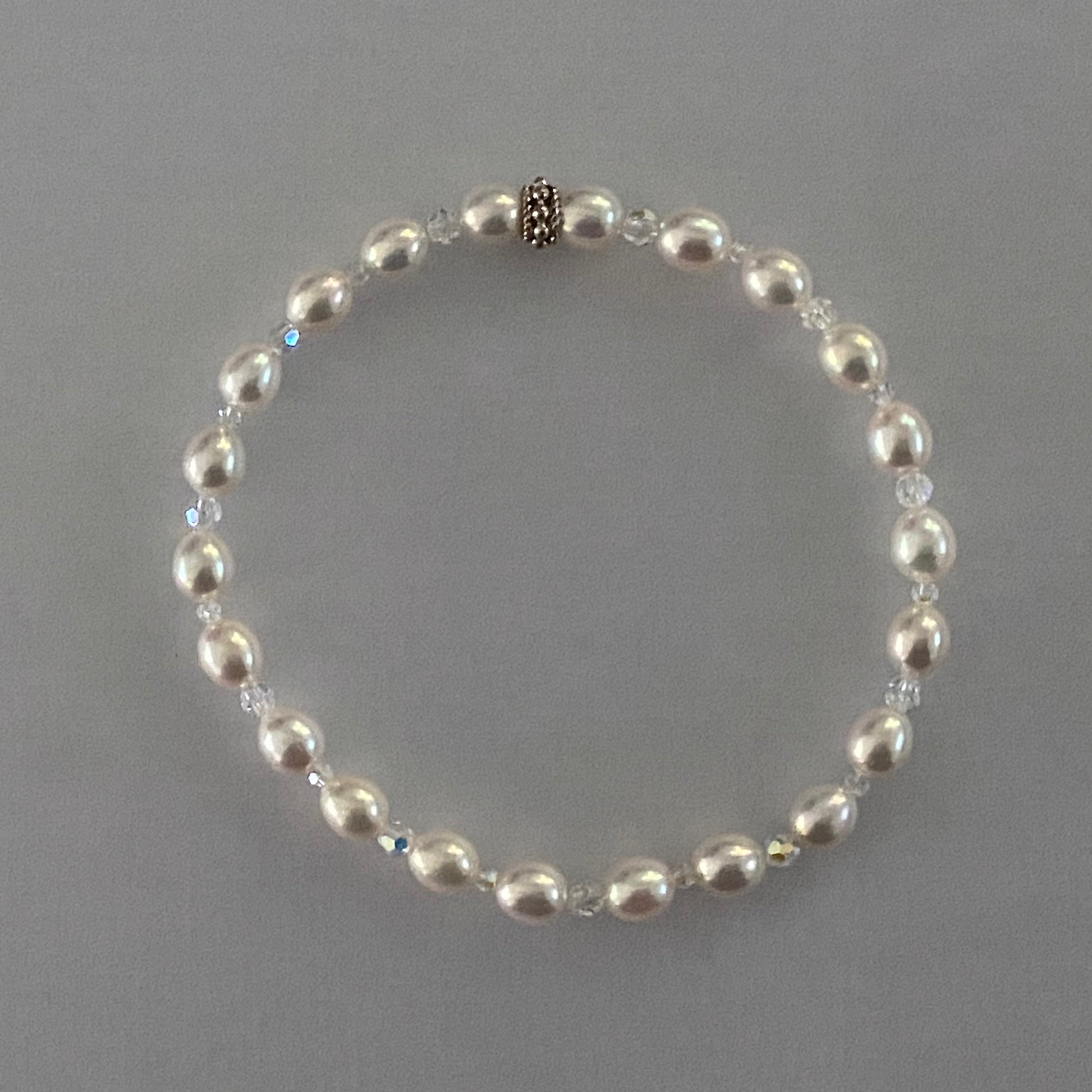 7-1/3" stretch bracelet with soft white color uniform oval shaped cultured freshwater pearls & Swarovski crystal beads / Arpaia Jewelry