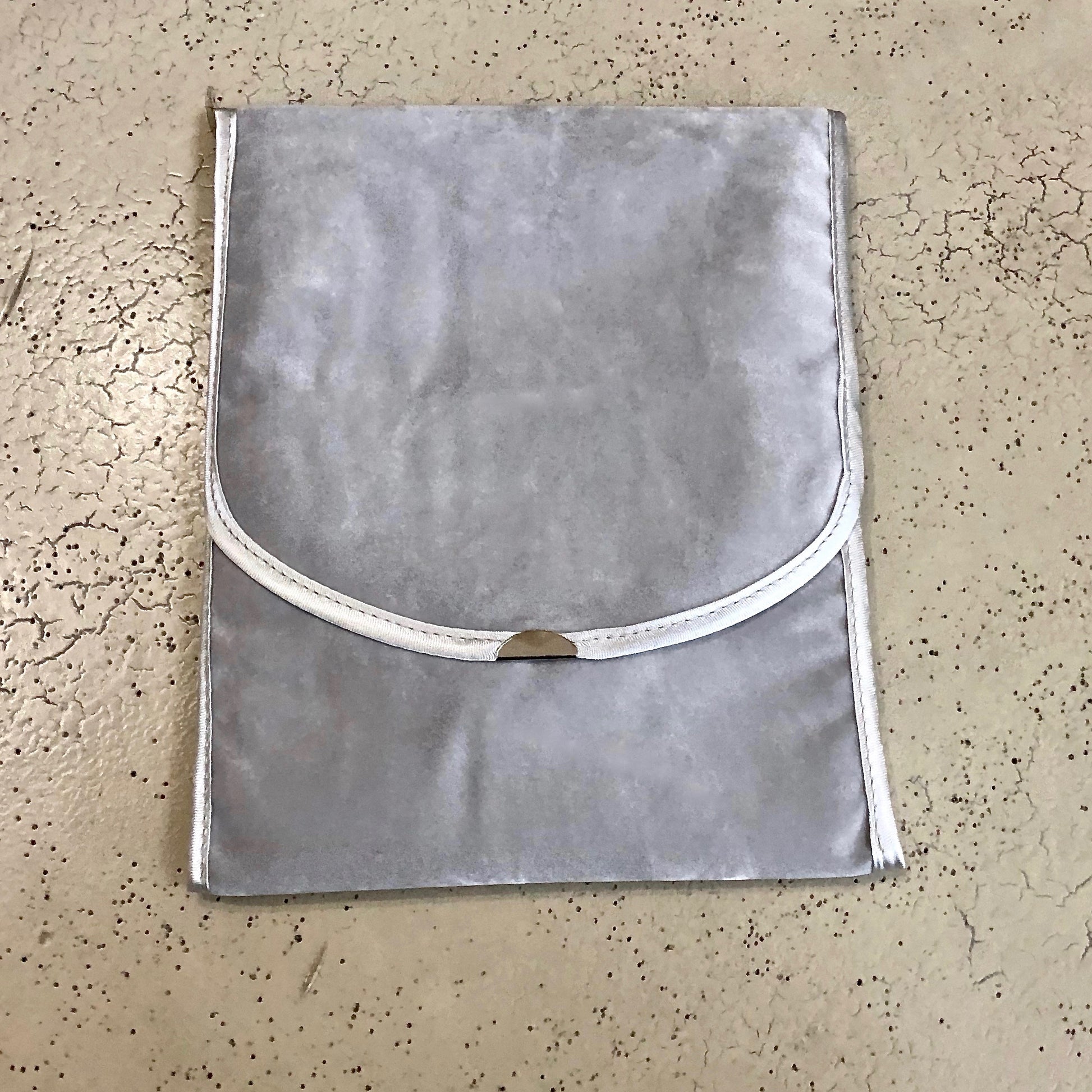 Italian faux suede jewelry folder closed with necklace inside