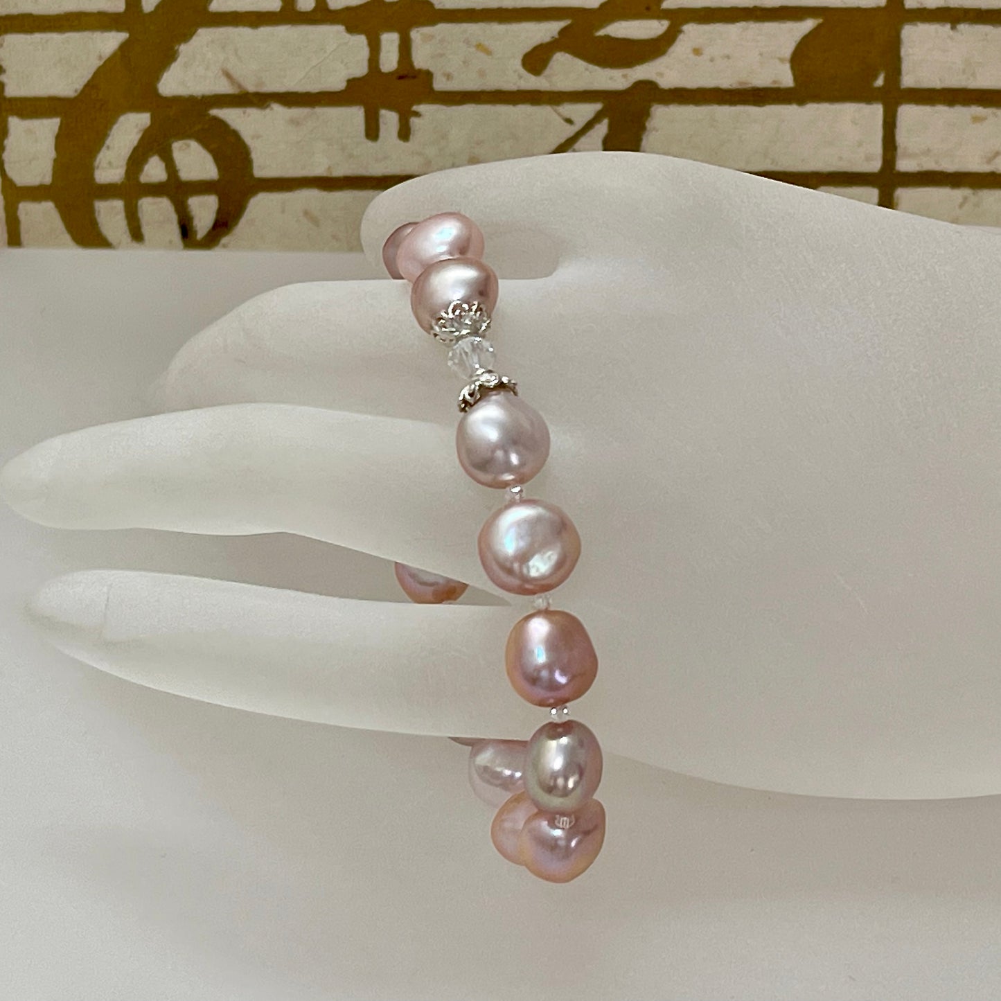 Pink nugget pearl bracelet shown on acrylic hand display