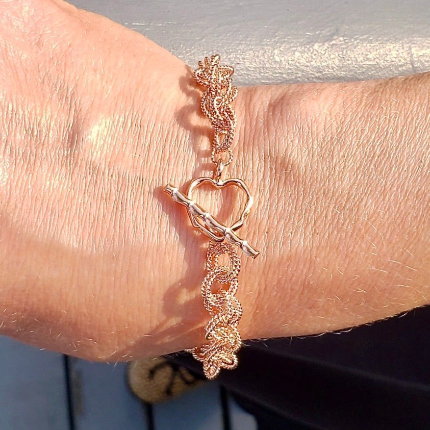 Arpaia Lang Rose Gold Vermeil Love Knots Bracelet on Model with Heart Clasp facing up - closeup outside natural light