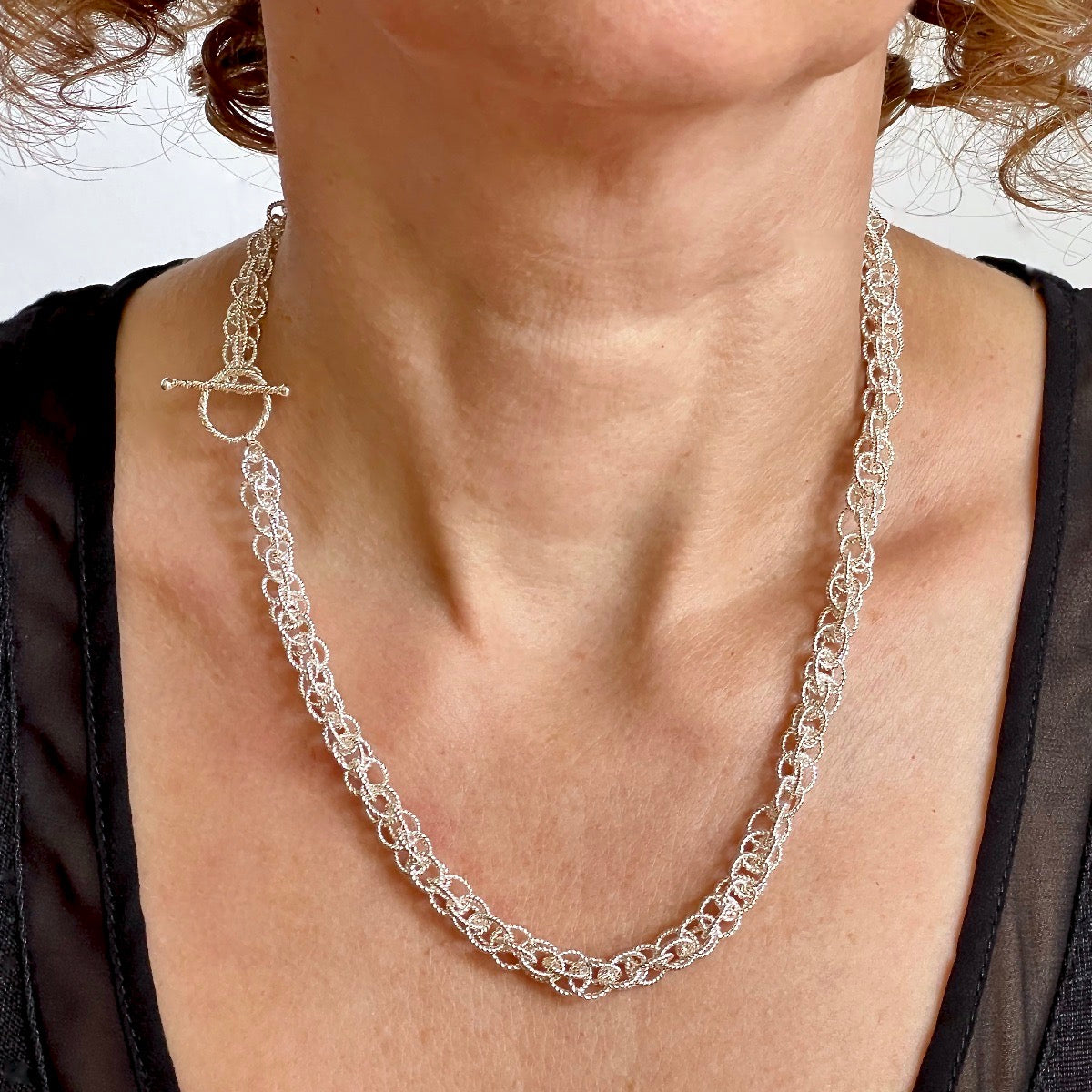 Silver Spinner Necklace on Model with clasp worn on side