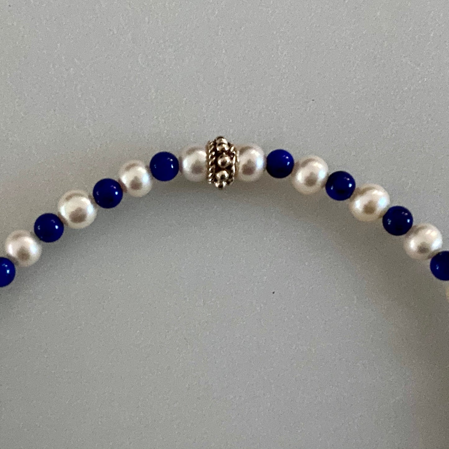 Clseup Arpaia lapis & CFWP stretch bracelet with silver bead