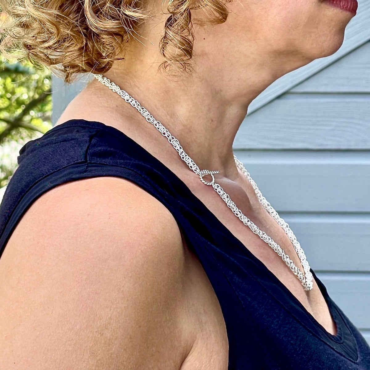 Side view of necklace on model with clasp worn on side / Arpaia Lang