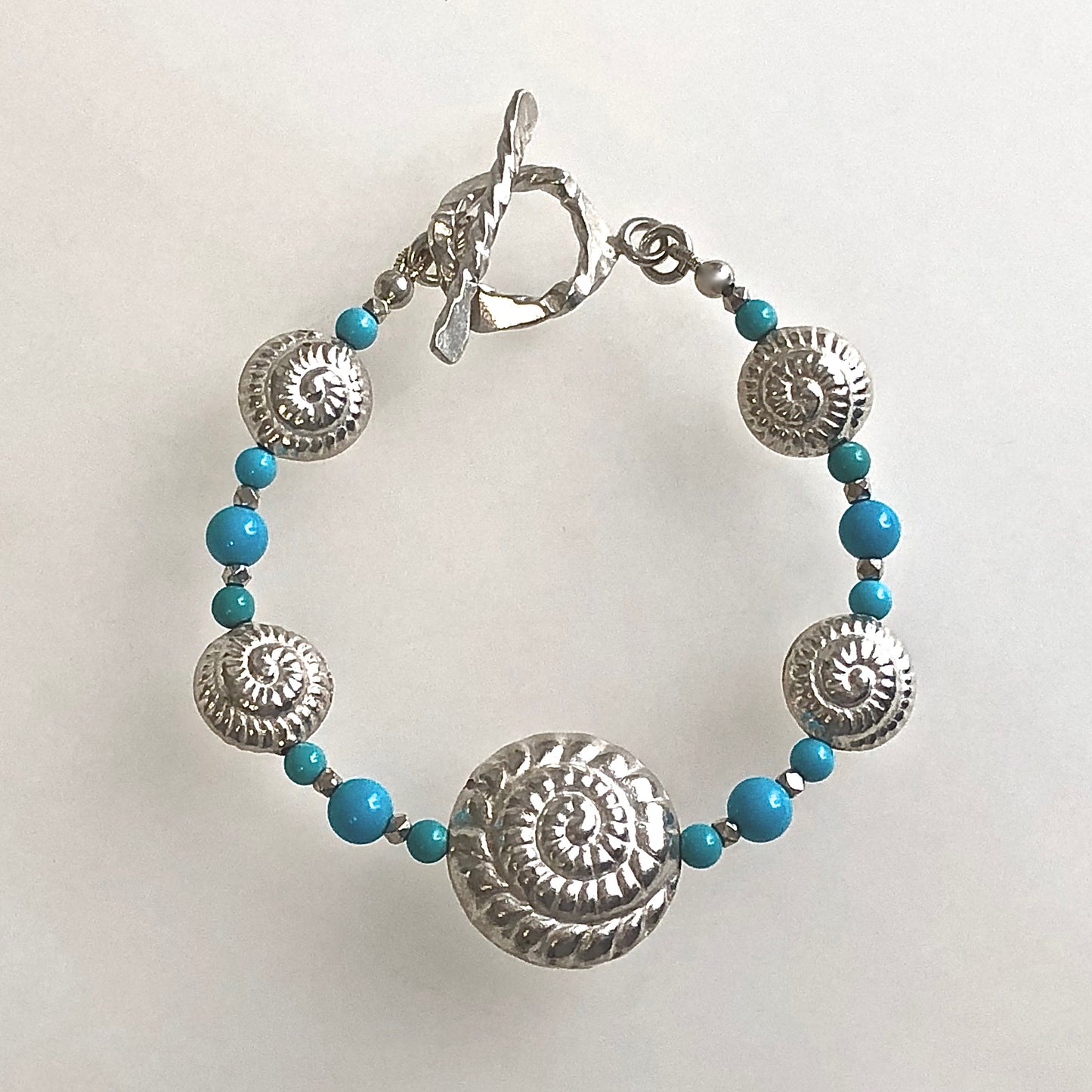 8" one of a kind Nautilus Shell Bracelet in artisan-crafted 999 Fine Silver with Sleeping Beauty Turquoise