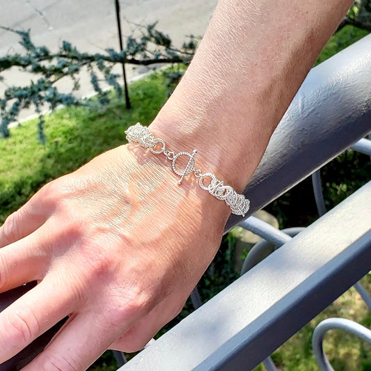 9mm Silver Saturn Bracelet - Closeup on model outside natural light