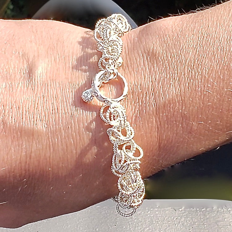 Arpaia Silver Frilly Bracelet on model with clasp face up - closeup outside natural light