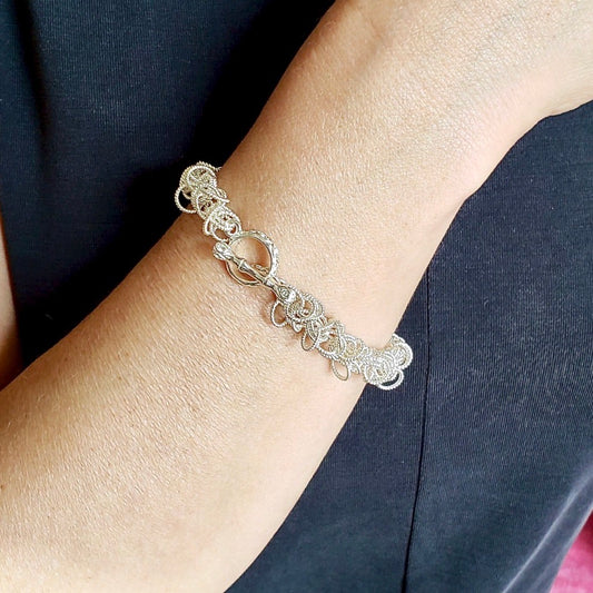 Arpaia Silver Frilly Bracelet on model with clasp face up - inside natural light