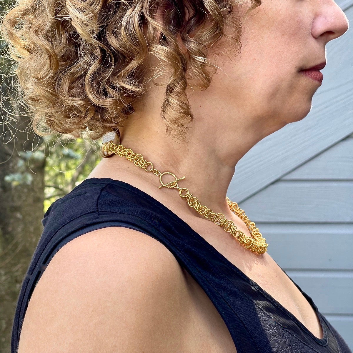 Side 19.5" Gold Vermeil 10mm Saturn Necklace on model with clasp worn to side / Arpaia Lang